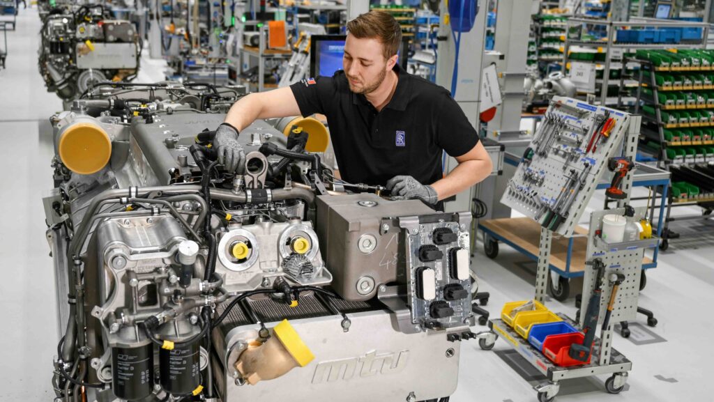 man working on large marine engine