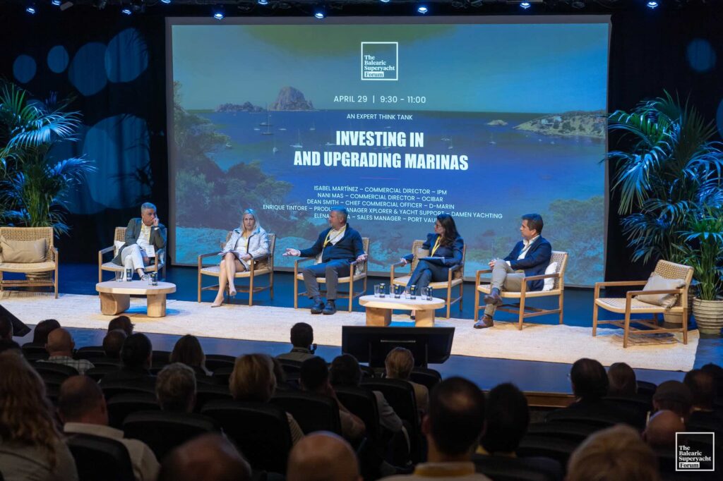 people sitting on stage in conference