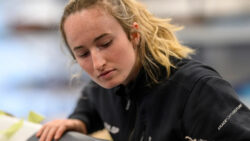 Sailor examines part of kit - image used to promote JUMP - the RYA and SailGP mentoring programme