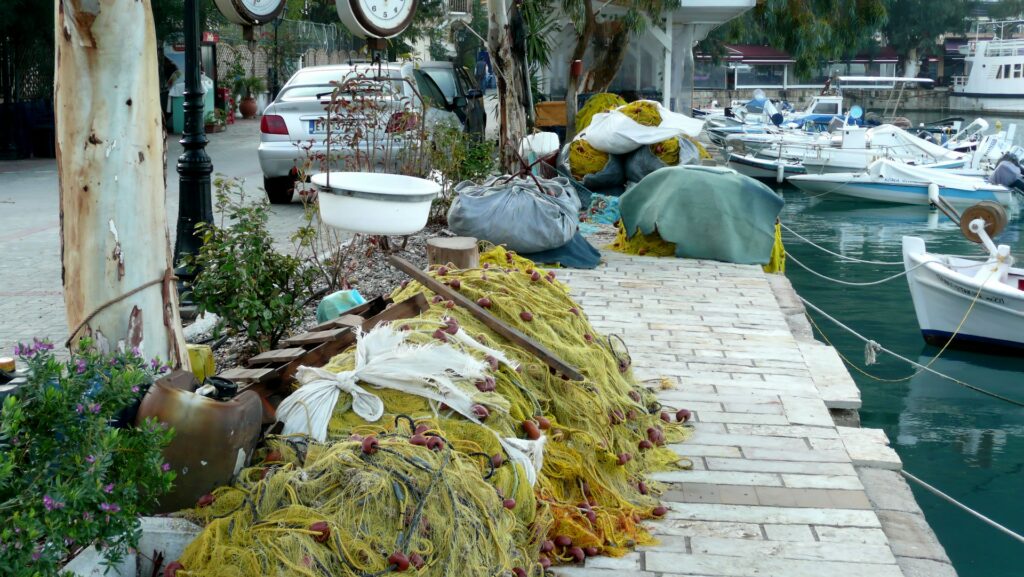 yellow fishing net in river bank with moored boats