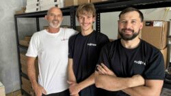 three men smiling at camera