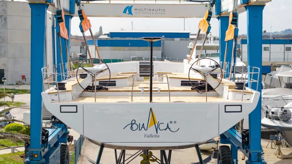 stern of Bianca II sail yacht in boat lift at shipyard