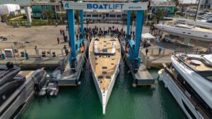large white sail boat in boat yard