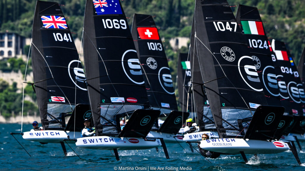 Black foiling boats during tight race