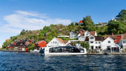 Hyke electric ferry on pretty Norwegian waterway