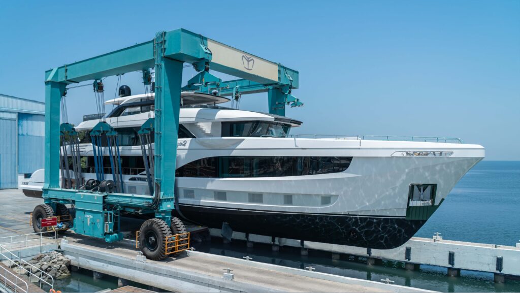 Majesty 145 superyacht in boat hoist on dockyard