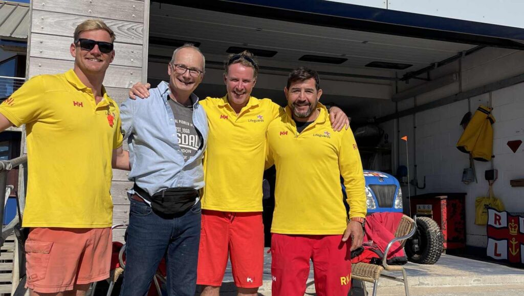 Richard Wright (second from left) with the RNLI lifeguards who saved him after he collapsed on Fistral Beach in Newquay