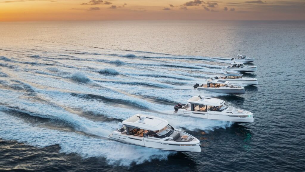 fleet of Saxdor motor yachts at sunset wake shot