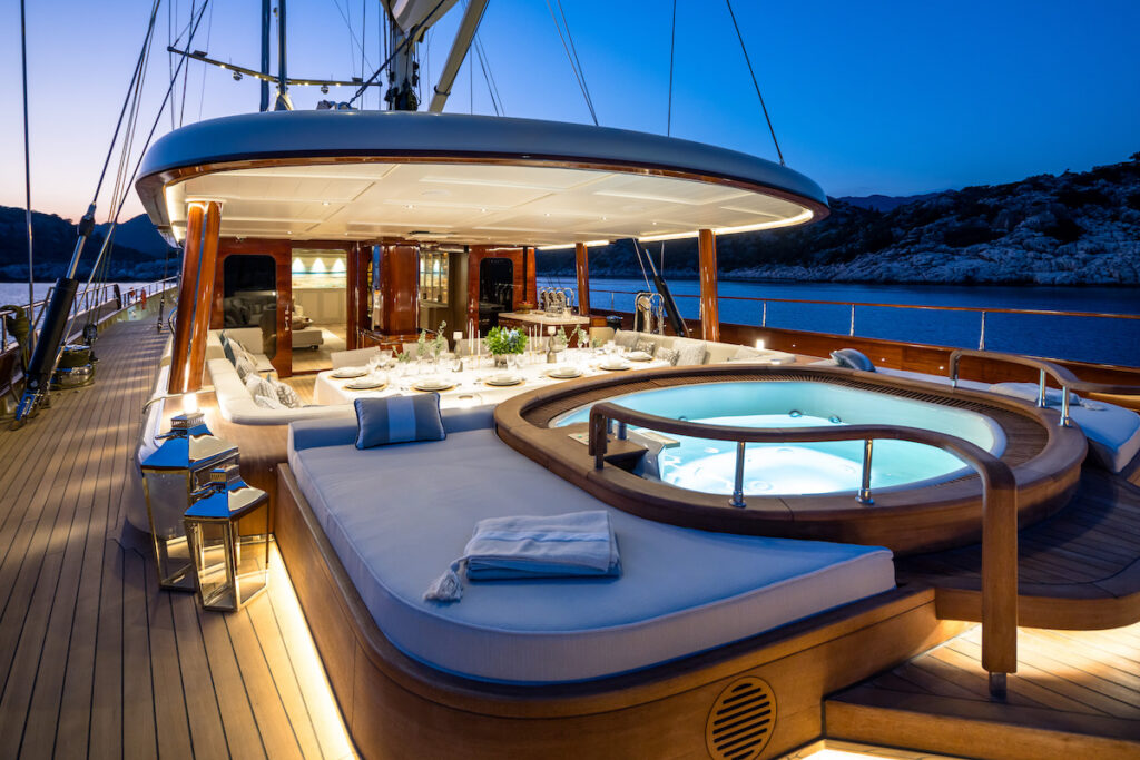 upper deck of sailing superyacht with Jacuzzi at night