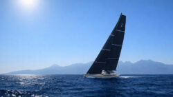 large modern sailing yacht with main sail up