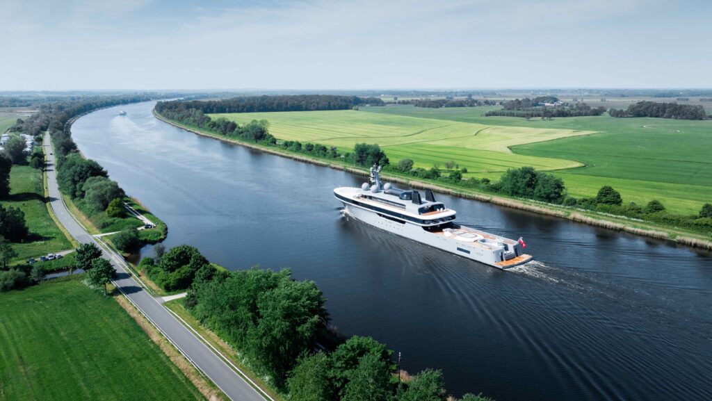 Lürssen's Nausiccä Image courtesy of Tomvan Oosanen - wide view of boat and green river banks