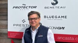 man in blue gilet and white shirt