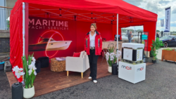 Fiona Pascoe from Maritime Yacht Services stands outside a red booth