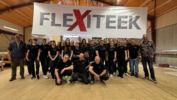 a group of people in front of a flexiteek sign