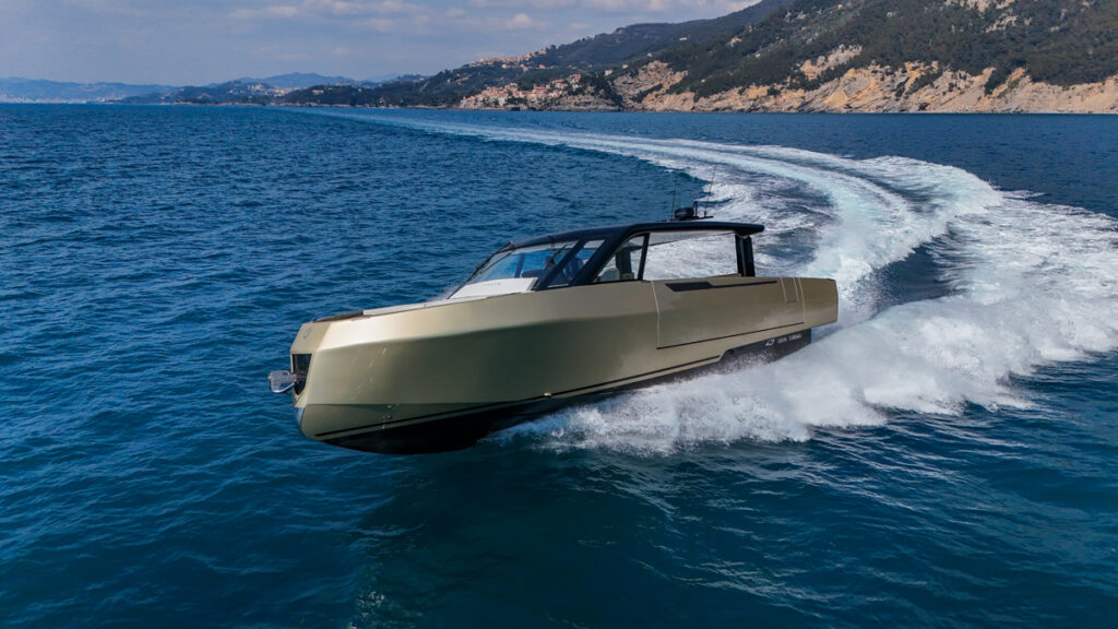 Gold hulled modern luxe speedboat wake shot