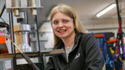 Woman in factory with safety glasses on