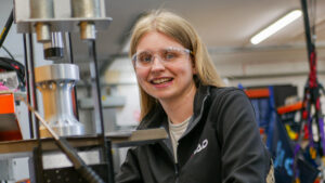 Woman in factory with safety glasses on