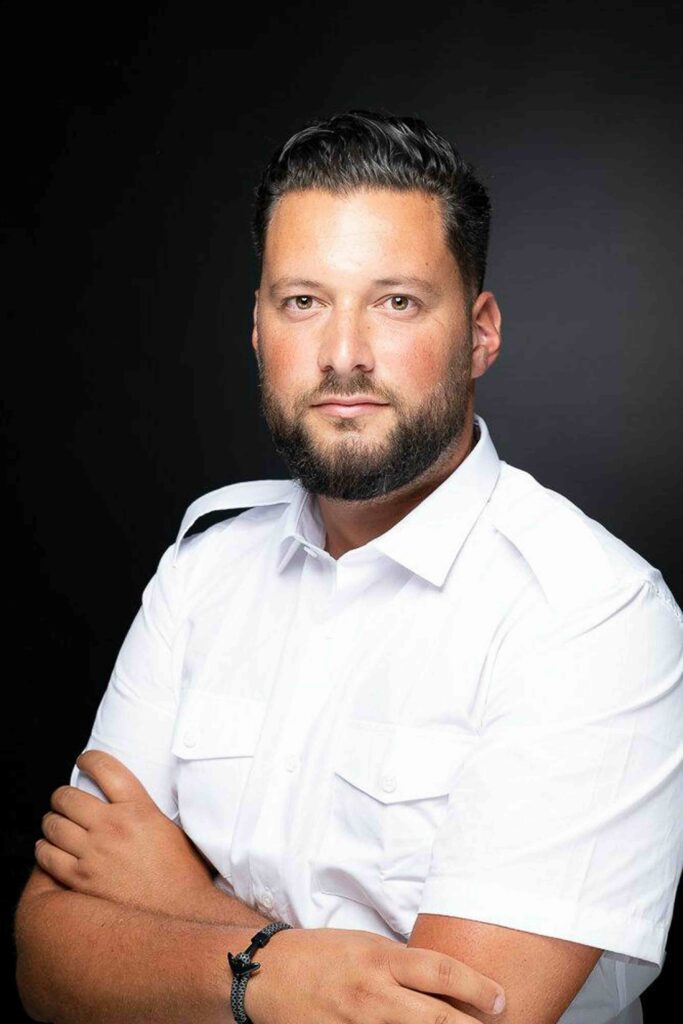 man in white shirt folded arms