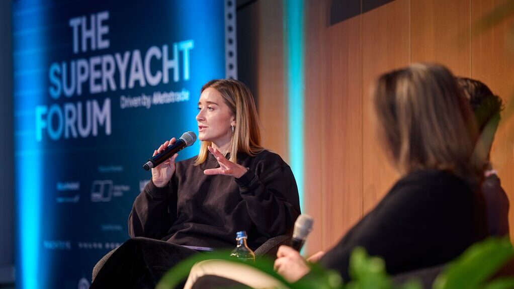 Woman speaking with mic on a stage