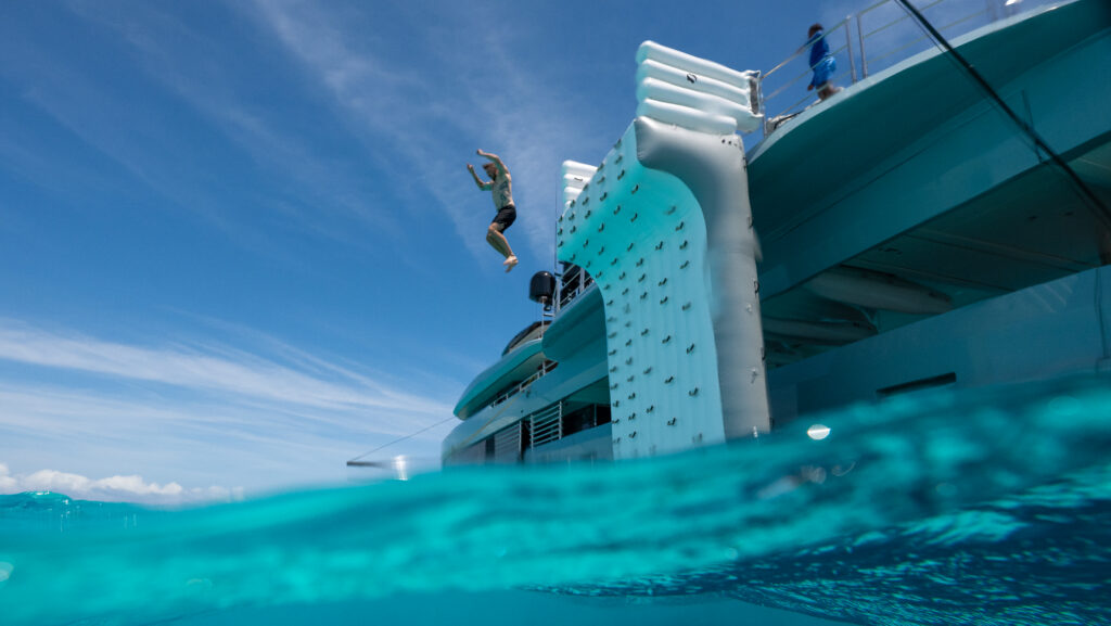 person jumping from superyacht inflatable wall