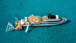 aerial view of superyacht with inflatable slides and helipad