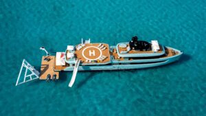 aerial view of superyacht with inflatable slides and helipad