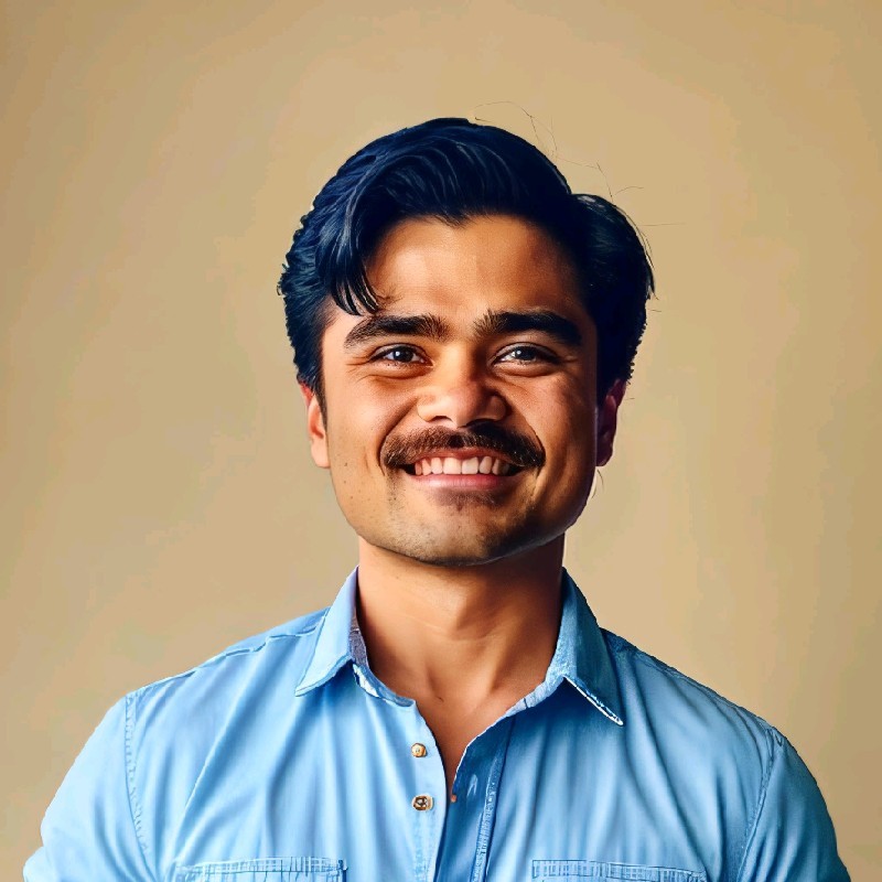 man smiling at camera in blue shirt