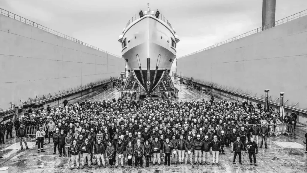 Workers in front of a new superyacht 