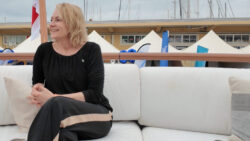 Tytti Sirola, founder of Bluet Floating Solutions sits on a boat