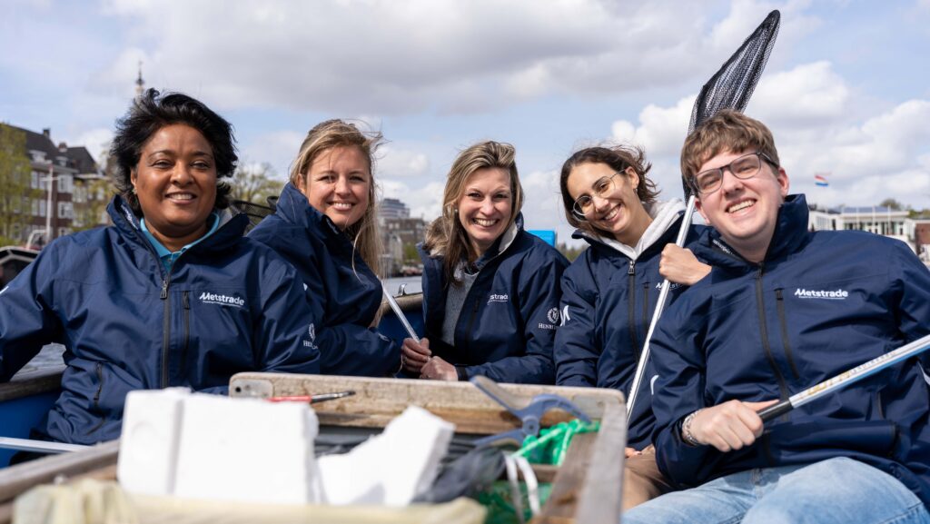 People on boat in Metstrade jackets with litter collected in canals