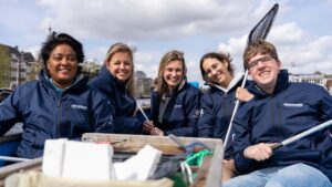 People on boat in Metstrade jackets with litter collected in canals