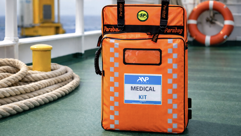 Orange medical emergency bag on deck of ship