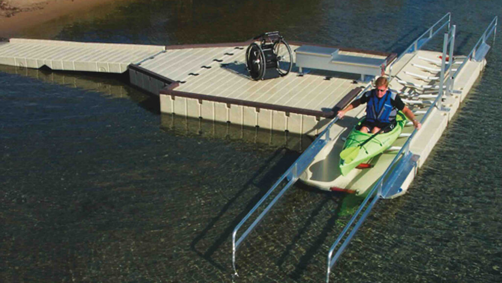 accessible launch for a kayak showing wheelchair user in kayak on dock prior to launching