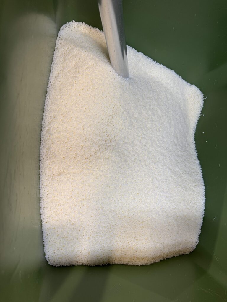 hopper with raw materials for making Flexiteek at the factory