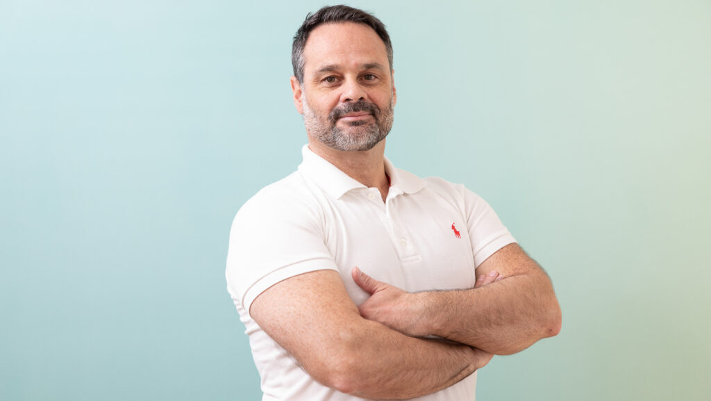 head shot of a man in a white polo shirt