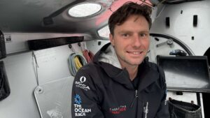 Lincoln Dews headshot onboard Oliver Heer's IMOCA