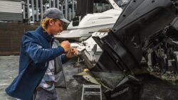 Man repairs boat at yard