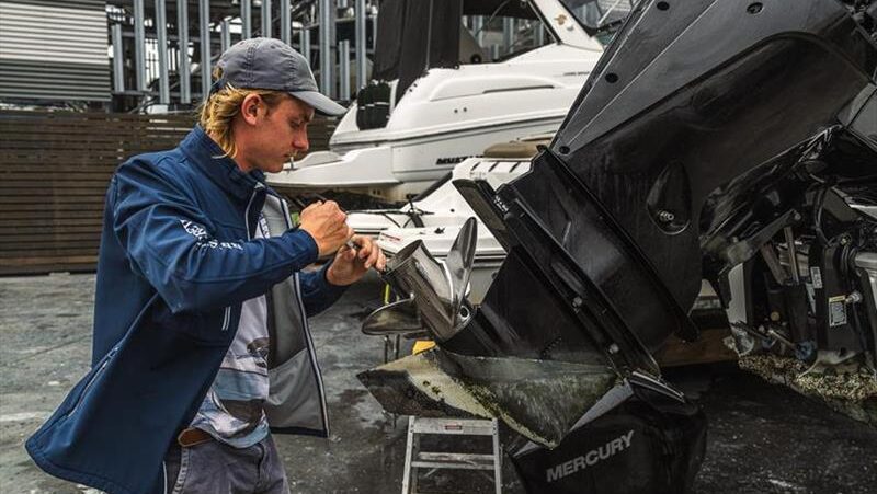 Man repairs boat at yard