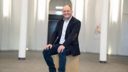 Reintjes Group managing director Klaus Deleroi sits on a box in a room