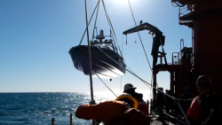Saronic Corsair being launched at sea - boat being lowered into water