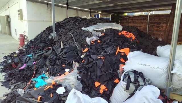 Pile of discarded wetsuits