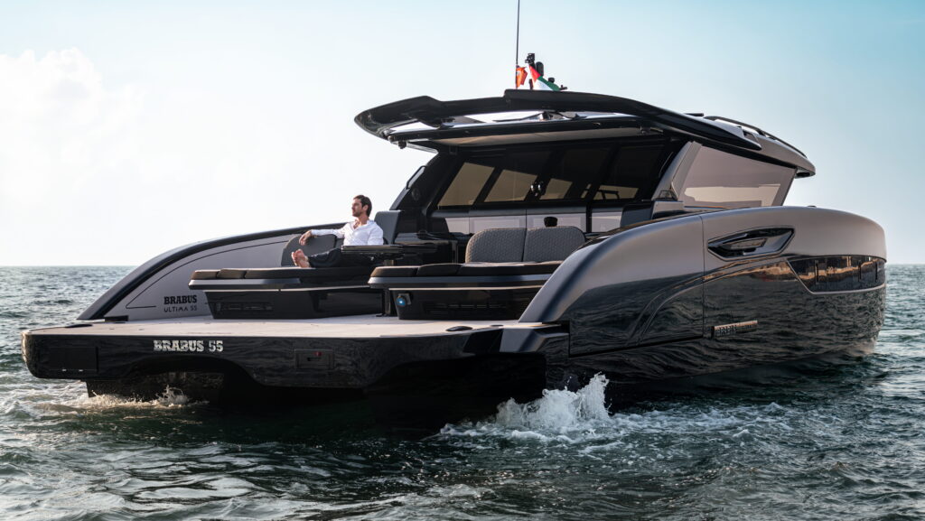 Rear three-quarter view of the BRABUS ULTIMA 55 luxury catamaran showing its aft deck and folding side platforms.