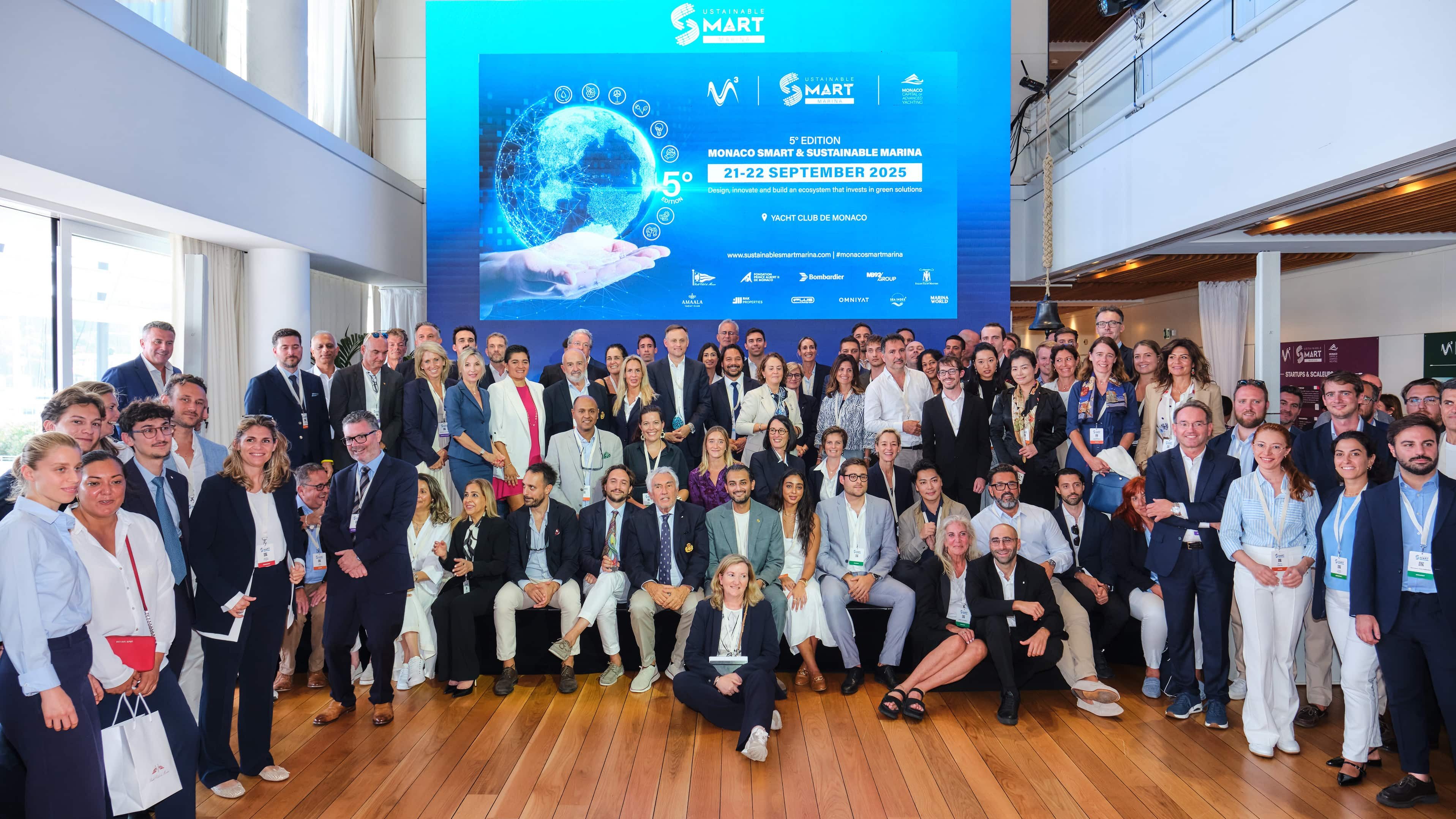 Attendees gather for a group photograph at the Monaco Smart & Sustainable Marina Rendezvous at the Yacht Club de Monaco.