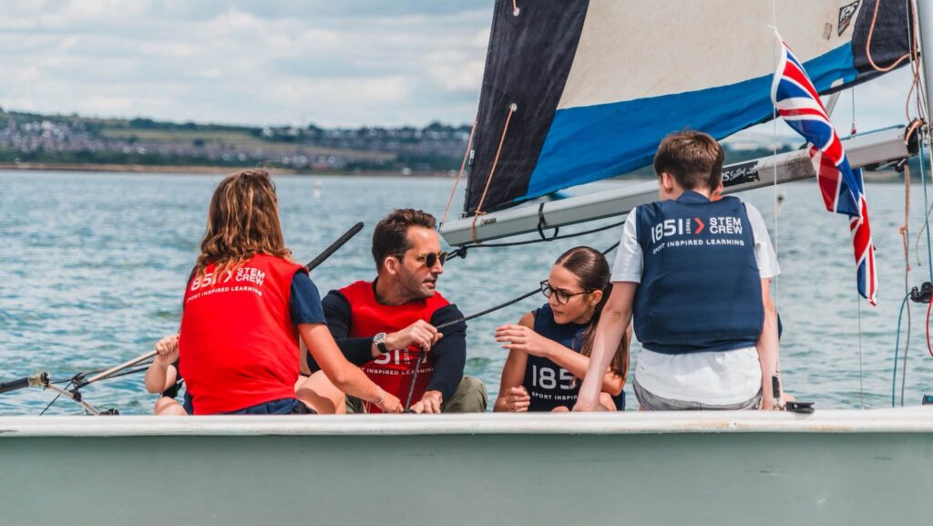 Sir Ben Ainslie sails with students during the STEM Crew Live programme