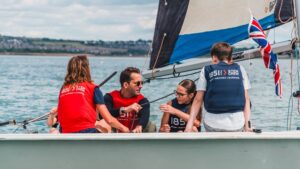 Sir Ben Ainslie sails with students during the STEM Crew Live programme