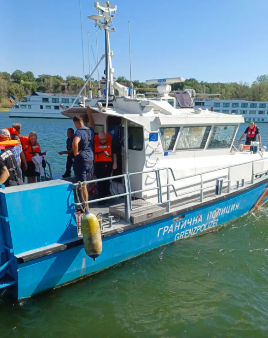 a border force boat on the river packing stranded cruise tourists into its hold