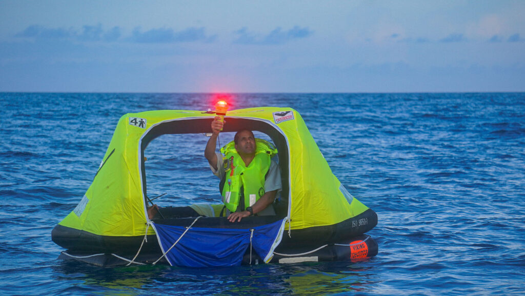 Electronic flare being used from a liferaft as an alternative to traditional pyrotechnic distress signals