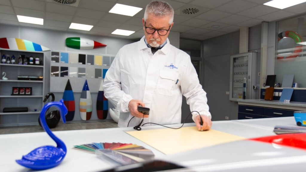 man in white coat tests product in Boero YachtCoatings HQ