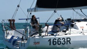 sailing yacht underway with two sailors