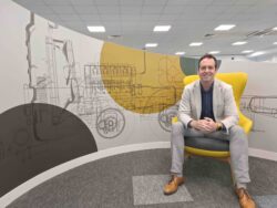 man in suit on yellow office chair